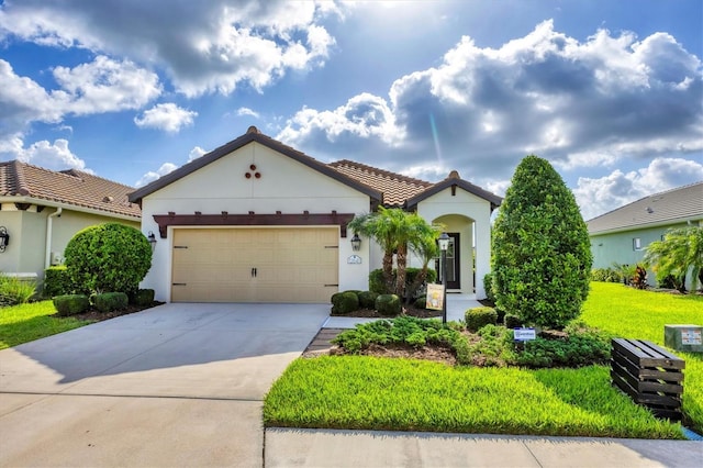 12641 Coastal Breeze Way, Bradenton, FL 34211 - mediterranean / spanish house featuring a garage, concrete driveway, and stucco siding