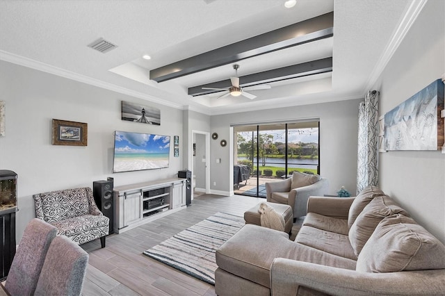 12641 Coastal Breeze Way, Bradenton, FL 34211 - living room with a raised ceiling, a ceiling fan, crown molding, recessed lighting, and light wood-style flooring