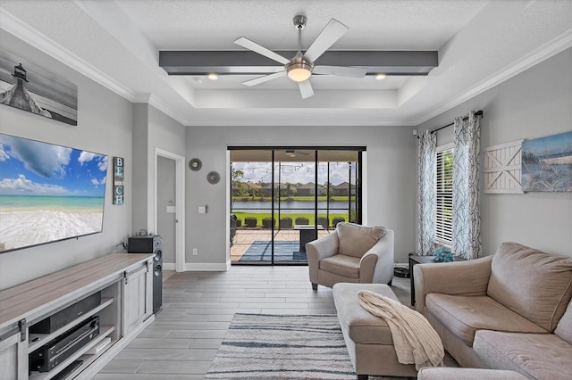 12641 Coastal Breeze Way, Bradenton, FL 34211 - living room with ceiling fan, wood tiled floors, a raised ceiling, a water view, and a textured ceiling