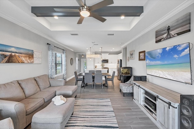 12641 Coastal Breeze Way, Bradenton, FL 34211 - living area with a tray ceiling, dark wood-style flooring, crown molding, ceiling fan, and recessed lighting