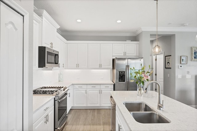 12641 Coastal Breeze Way, Bradenton, FL 34211 - kitchen featuring stainless steel appliances, light wood-type flooring, crown molding, white cabinetry, and backsplash