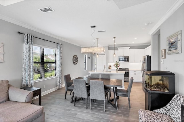 12641 Coastal Breeze Way, Bradenton, FL 34211 - dining room featuring ornamental molding, light wood-type flooring, a chandelier, and recessed lighting