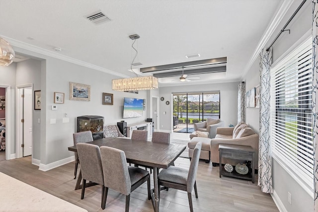 12641 Coastal Breeze Way, Bradenton, FL 34211 - dining space with ceiling fan, light wood-type flooring, and ornamental molding