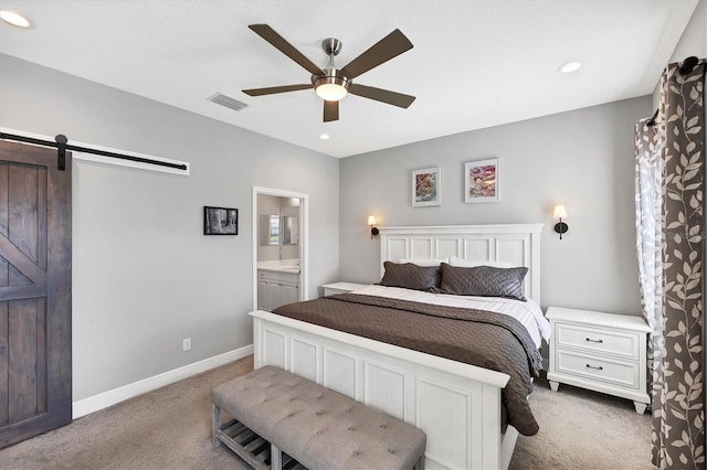 12641 Coastal Breeze Way, Bradenton, FL 34211 - carpeted bedroom with a barn door, ensuite bathroom, a ceiling fan, and recessed lighting