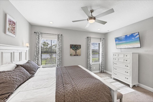 12641 Coastal Breeze Way, Bradenton, FL 34211 - bedroom with multiple windows, light colored carpet, recessed lighting, ceiling fan, and a textured ceiling