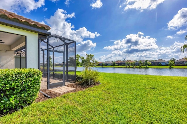 12641 Coastal Breeze Way, Bradenton, FL 34211 - view of green lawn featuring a water view, a residential view, and glass enclosure