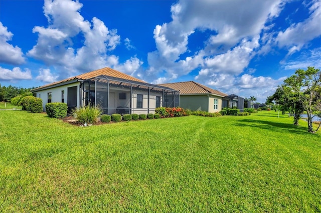 12641 Coastal Breeze Way, Bradenton, FL 34211 - back of property with a tiled roof, a yard, stucco siding, and a lanai