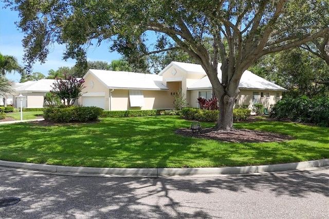 7904 Hampton Ct, University Park, FL 34201 - single story home featuring a garage, a front yard, and stucco siding