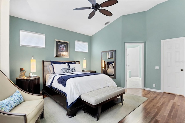 7904 Hampton Ct, University Park, FL 34201 - bedroom featuring high vaulted ceiling, wood finished floors, ensuite bath, and ceiling fan