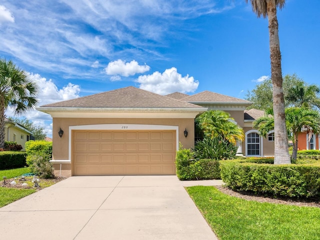 280 Dahlia Ct, Bradenton, FL 34212 - view of front of property featuring stucco siding, concrete driveway, and a garage