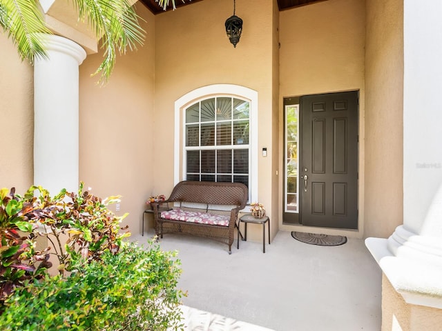 280 Dahlia Ct, Bradenton, FL 34212 - doorway to property featuring stucco siding and a porch