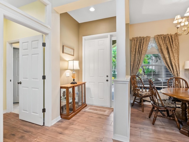 280 Dahlia Ct, Bradenton, FL 34212 - foyer featuring light wood-type flooring, a chandelier, and ornate columns