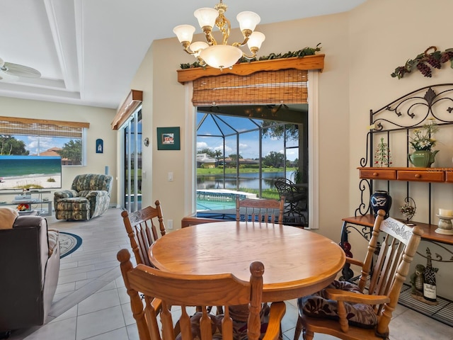 280 Dahlia Ct, Bradenton, FL 34212 - dining space featuring a chandelier, a water view, a sunroom, and light tile patterned floors