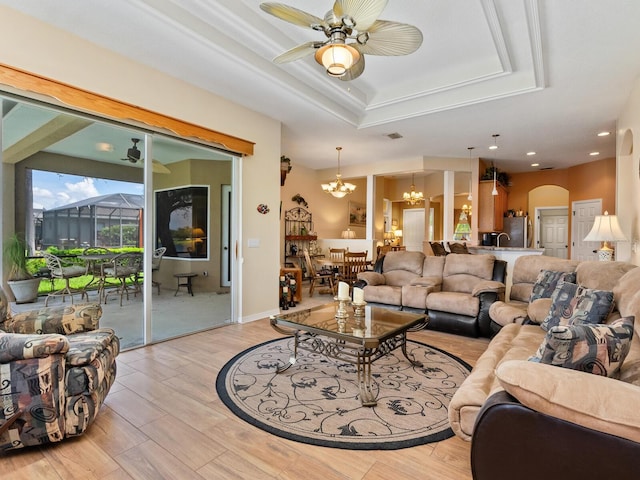 280 Dahlia Ct, Bradenton, FL 34212 - living room featuring a raised ceiling, a chandelier, light wood-type flooring, a ceiling fan, and recessed lighting