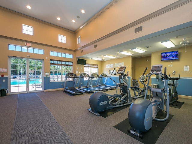 280 Dahlia Ct, Bradenton, FL 34212 - workout area featuring carpet, plenty of natural light, ornamental molding, recessed lighting, and a high ceiling