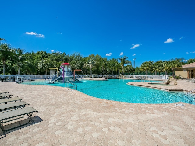 280 Dahlia Ct, Bradenton, FL 34212 - community pool with a patio and view of wooded area