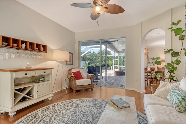 730 137th St NE, Bradenton, FL 34212 - living room with a ceiling fan, a sunroom, arched walkways, and wood finished floors