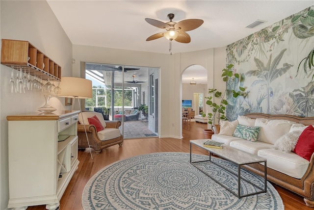 730 137th St NE, Bradenton, FL 34212 - living area with a ceiling fan, arched walkways, and wood finished floors