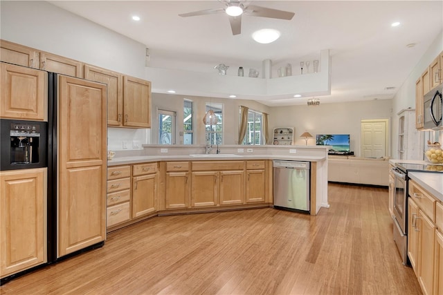 730 137th St NE, Bradenton, FL 34212 - kitchen featuring appliances with stainless steel finishes, light brown cabinets, light wood-style flooring, open floor plan, and recessed lighting