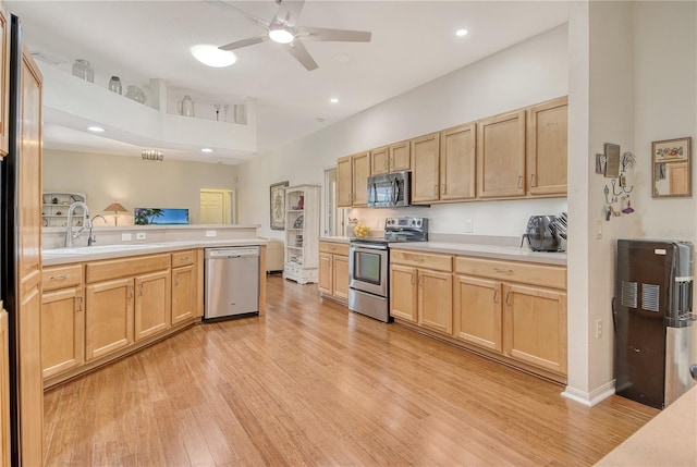 730 137th St NE, Bradenton, FL 34212 - kitchen with appliances with stainless steel finishes, light brown cabinets, a peninsula, light countertops, and recessed lighting