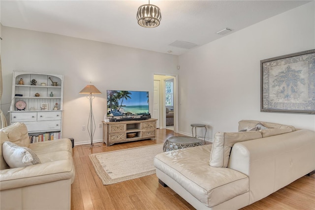 730 137th St NE, Bradenton, FL 34212 - living room featuring light wood-style floors and baseboards