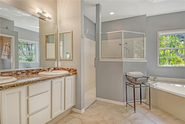 730 137th St NE, Bradenton, FL 34212 - bathroom featuring walk in shower, a bath, double vanity, decorative backsplash, and tile patterned flooring