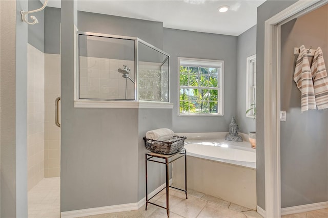 730 137th St NE, Bradenton, FL 34212 - bathroom with a shower stall, a bath, and tile patterned flooring