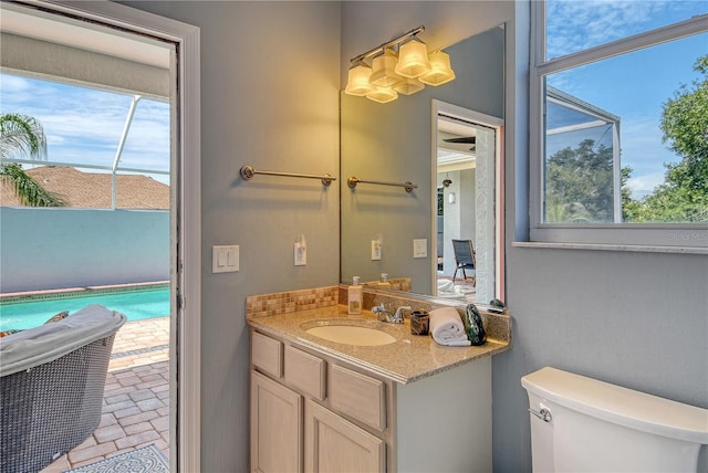 730 137th St NE, Bradenton, FL 34212 - bathroom featuring vanity, plenty of natural light, and brick patterned floors