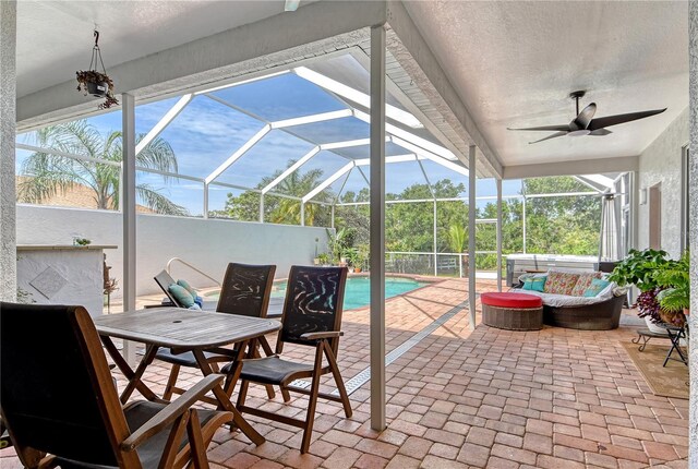 730 137th St NE, Bradenton, FL 34212 - view of patio / terrace featuring ceiling fan, an outdoor living space, glass enclosure, an outdoor pool, and outdoor dining area