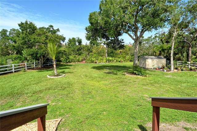 730 137th St NE, Bradenton, FL 34212 - view of yard featuring a storage unit and view of wooded area