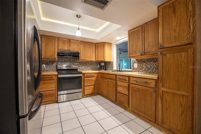 1208 Francis Ave, Sarasota, FL 34232 - kitchen with stainless steel appliances, ventilation hood, brown cabinets, and tasteful backsplash
