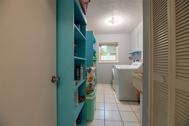 1208 Francis Ave, Sarasota, FL 34232 - laundry area featuring separate washer and dryer, a textured ceiling, and light tile patterned floors