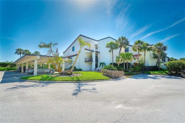 2039 Gulf Of Mexico Dr Unit G3-207, Longboat Key, FL 34228 - mediterranean / spanish-style home featuring covered parking and stucco siding
