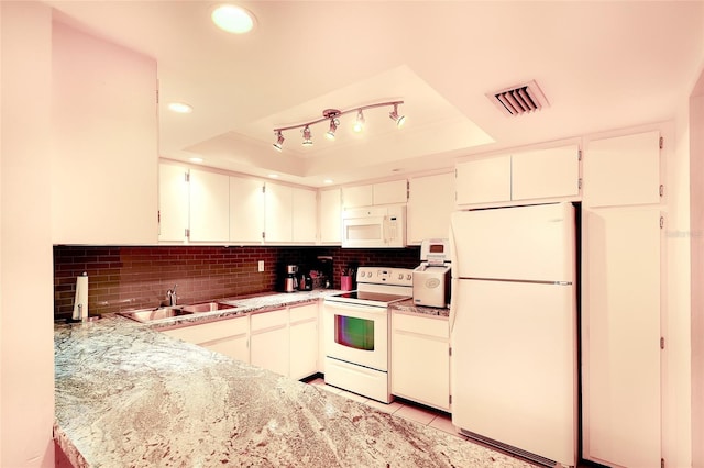 2039 Gulf Of Mexico Dr Unit G3-207, Longboat Key, FL 34228 - kitchen featuring white appliances, a raised ceiling, decorative backsplash, recessed lighting, and light tile patterned flooring