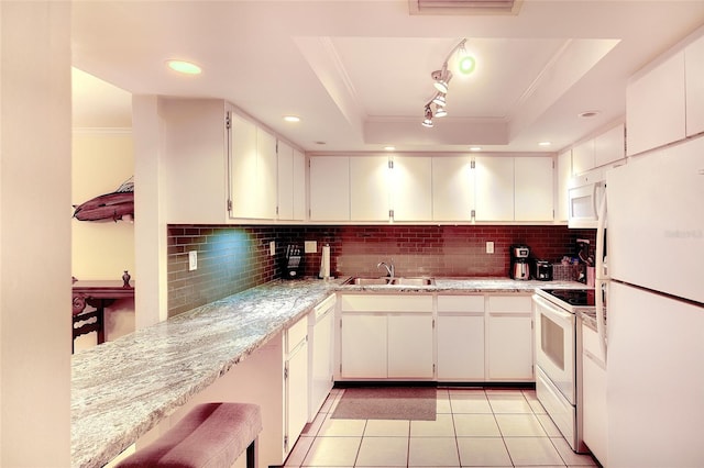 2039 Gulf Of Mexico Dr Unit G3-207, Longboat Key, FL 34228 - kitchen featuring white appliances, ornamental molding, backsplash, light tile patterned floors, and a tray ceiling