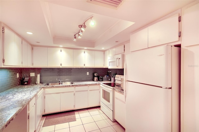 2039 Gulf Of Mexico Dr Unit G3-207, Longboat Key, FL 34228 - kitchen featuring white appliances, a tray ceiling, tasteful backsplash, light tile patterned floors, and ornamental molding