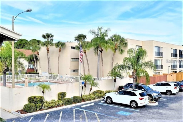 2763 Woodgate Ln Unit 105, Sarasota, FL 34231 - view of property featuring uncovered parking