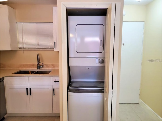 2763 Woodgate Ln Unit 105, Sarasota, FL 34231 - laundry area featuring stacked washer / dryer and light tile patterned flooring