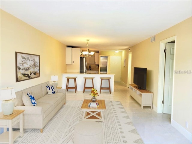 2763 Woodgate Ln Unit 105, Sarasota, FL 34231 - living room featuring light tile patterned flooring and baseboards