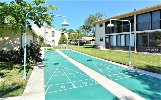2763 Woodgate Ln Unit 105, Sarasota, FL 34231 - surrounding community featuring a lawn and shuffleboard
