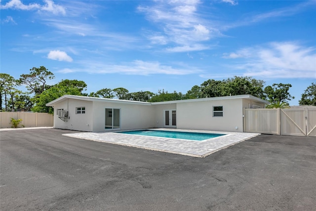 4515 19th Ave W, Bradenton, FL 34209 - back of house featuring french doors, a gate, stucco siding, and a patio area