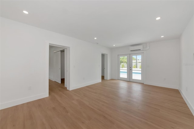 4515 19th Ave W, Bradenton, FL 34209 - unfurnished room featuring recessed lighting, light wood finished floors, an AC wall unit, and french doors