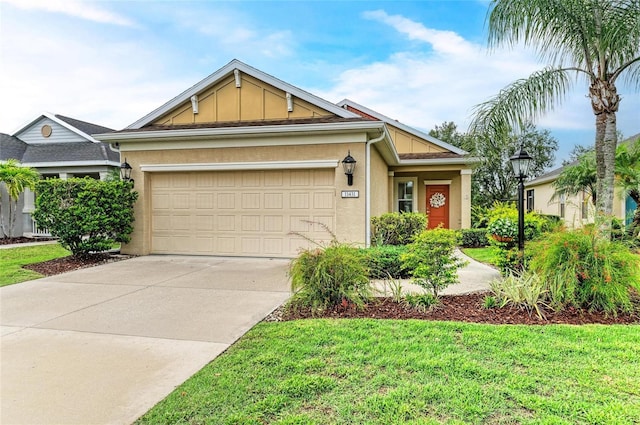 11431 Piedmont Park Xing, Bradenton, FL 34211 - view of front of home featuring a garage, stucco siding, driveway, and a front lawn