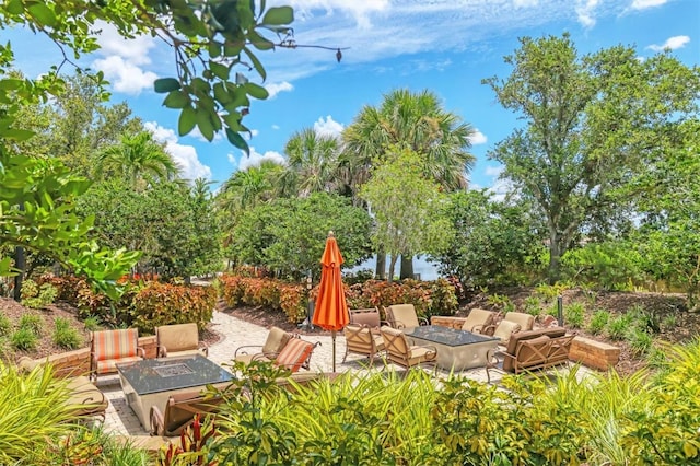 5596 Cantucci St, Nokomis, FL 34275 - view of yard featuring an outdoor fire pit and a patio area