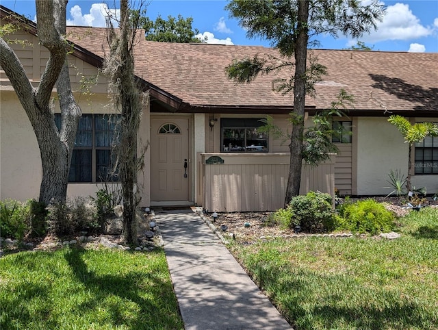 5231 Brassy Loop, North Port, FL 34287 - view of front of property with roof with shingles, stucco siding, and a front yard