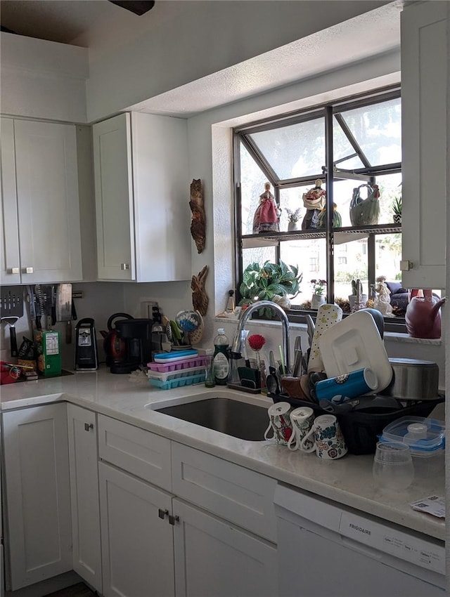 5231 Brassy Loop, North Port, FL 34287 - kitchen with dishwasher, white cabinetry, and light countertops