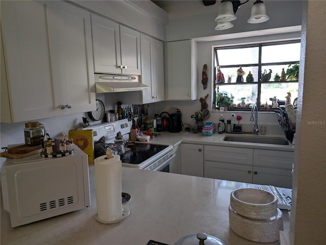 5231 Brassy Loop, North Port, FL 34287 - kitchen featuring white electric range, under cabinet range hood, white cabinets, and light countertops