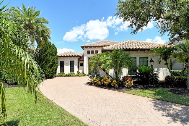 7638 Windy Hill Cv, Bradenton, FL 34202 - mediterranean / spanish-style house featuring a tiled roof, stucco siding, and decorative driveway