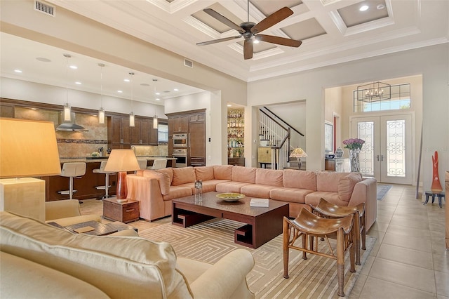 7638 Windy Hill Cv, Bradenton, FL 34202 - living area with coffered ceiling, a towering ceiling, stairway, a ceiling fan, and crown molding