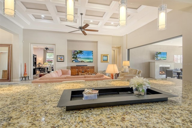 7638 Windy Hill Cv, Bradenton, FL 34202 - living room with ceiling fan, a lit fireplace, coffered ceiling, a towering ceiling, and beam ceiling